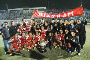 The Mizoram players and officials celebrating with the trophy.