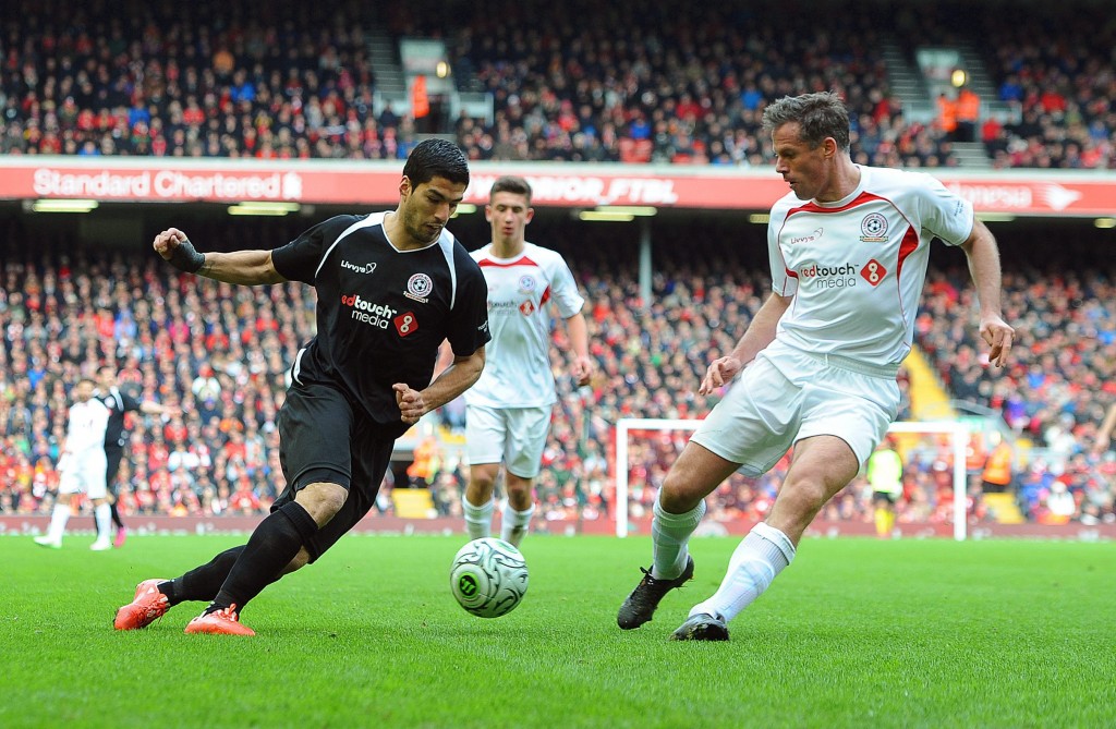 epa04685460 Luis Suarez (L) in action against Jamie Carragher (R) during the Liverpool All-Star charity soccer match at Anfield in Liverpool, Britain, 29 March 2015. EPA/PETER POWELL