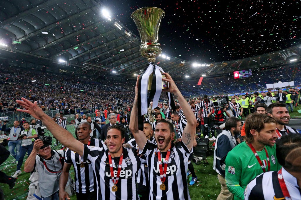Goalscorer Alessandro Matri (L) and Leonardo Bonucci celebrate with the trophy 