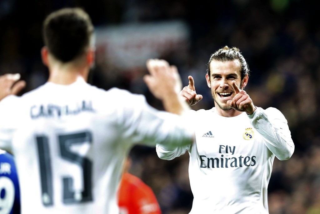 Real Madrid's Welsh winger Gareth Bale (R) celebrates with Dani Carvajal (L) after scoring the 2-0 lead against Deportivo Coruna during the Spanish Liga Primera Divison soccer match played at Santiago Bernabeu stadium, in Madrid, Spain, 09 January 2016. (Photo by Mariscal/EPA)