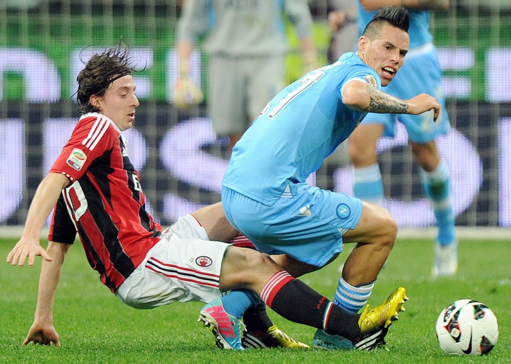 epa03662358 Napoli midfielder Marek Hamsik (R) is challenged for the ball by A.C. Milan midfielder Riccardo Montolivo during their Serie A soccer match at the Guseppe Meazza stadium in Milan, Italy, 14 April 2013. EPA/DANIEL DAL ZENNARO
