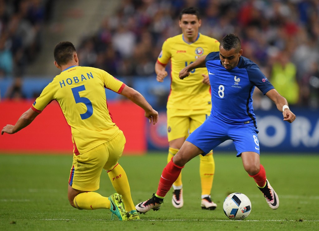 PARIS, FRANCE - JUNE 10: Dimitri Payet of France and Ovidiu Hoban of Romania compete for the ball during the UEFA Euro 2016 Group A match between France and Romania at Stade de France on June 10, 2016 in Paris, France. (Photo by Matthias Hangst/Getty Images)