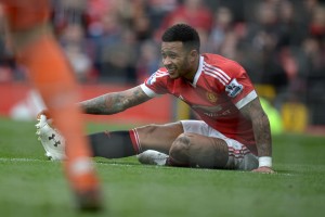 Manchester United's Dutch midfielder Memphis Depay stretches on the pitch during the English Premier League football match between Manchester United and Aston Villa at Old Trafford in Manchester, north west England, on April 16, 2016. / AFP / OLI SCARFF / RESTRICTED TO EDITORIAL USE. No use with unauthorized audio, video, data, fixture lists, club/league logos or 'live' services. Online in-match use limited to 75 images, no video emulation. No use in betting, games or single club/league/player publications. / (Photo credit should read OLI SCARFF/AFP/Getty Images)