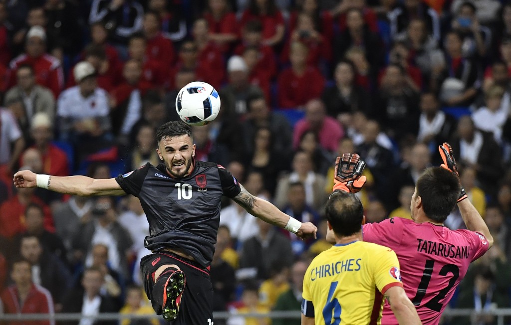 Albania's forward Armando Sadiku (L) scores the opening goal past Romania's goalkeeper Ciprian Anton Tatarusanu (C) and Romania's defender Vlad Chiriches during the Euro 2016 group A football match between Romania and Albania at the Parc Olympique Lyonnais stadium in Lyon on June 19, 2016. / AFP / jeff pachoud (Photo credit should read JEFF PACHOUD/AFP/Getty Images)