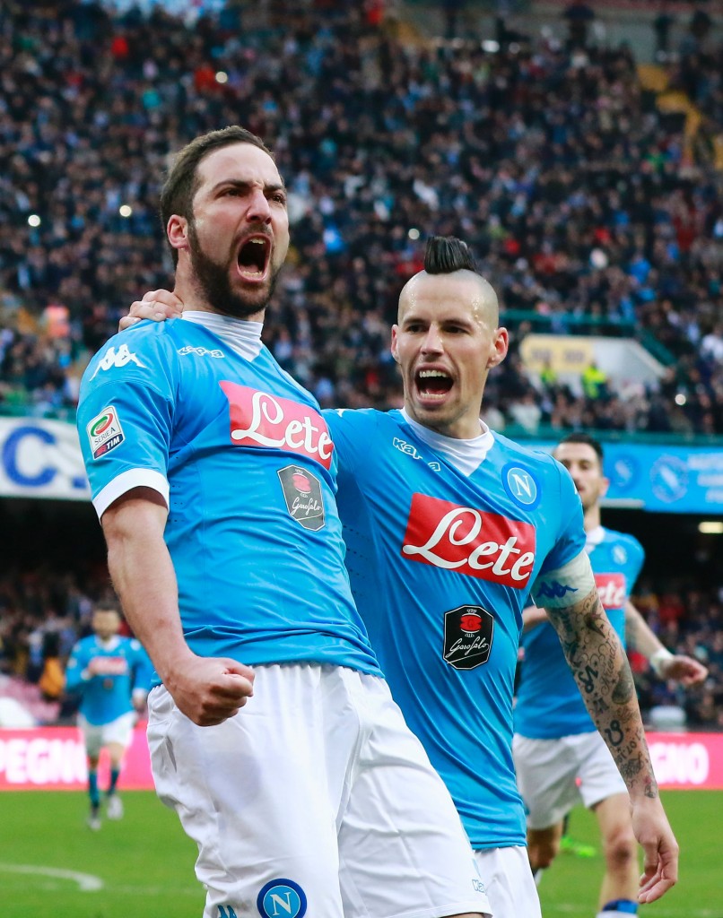 Napoli's Argentinian-French forward Gonzalo Higuain (L) celebrates after scoring with midfielder Marek Hamsik during the Italian Serie A football match SSC Napoli vs Carpi FC on February 7, 2016 at the San Paolo stadium in Naples. / AFP / CARLO HERMANN (Photo credit should read CARLO HERMANN/AFP/Getty Images)