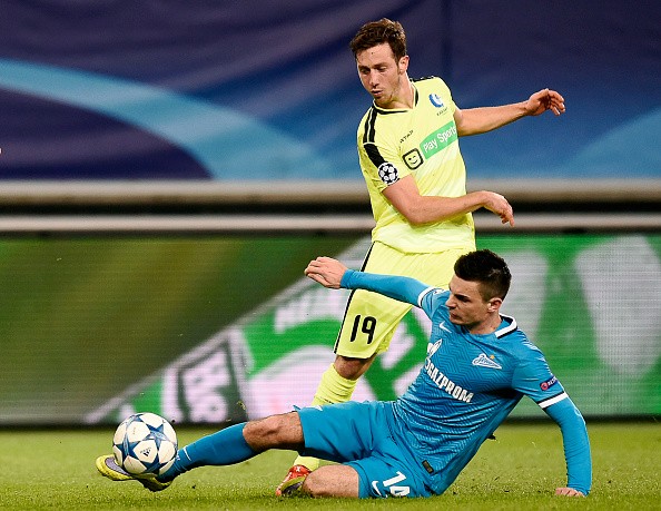 Gent's Belgian midfielder Brecht Dejaegere (top) vies for the ball against Zenit's defender Artur Yusupov during the UEFA Champions' League, Group H, football match KAA Gent vs FC Zenit on December 9, 2015 at the KAA Gent Stadium in Gent. Gent won 2-1. AFP PHOTO / JOHN THYS / AFP / JOHN THYS (Photo credit should read JOHN THYS/AFP/Getty Images)