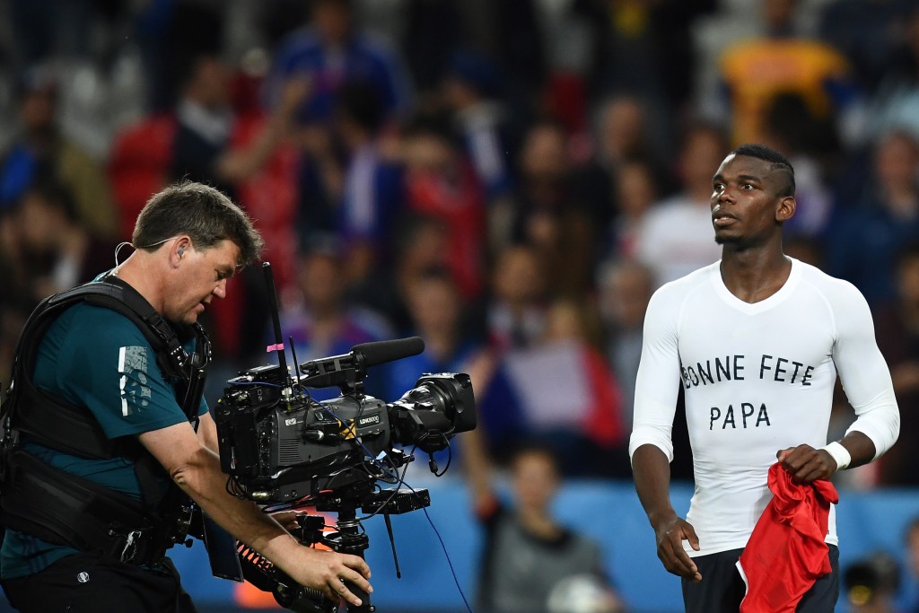 France's midfielder Paul Pogba wears a shirt that reads "Happy father's day" acknowledges the crowd following their 0-0 draw in the Euro 2016 group A football match between Switzerland and France at the Pierre-Mauroy stadium in Lille on June 19, 2016. / AFP / FRANCK FIFE (Photo credit should read FRANCK FIFE/AFP/Getty Images)