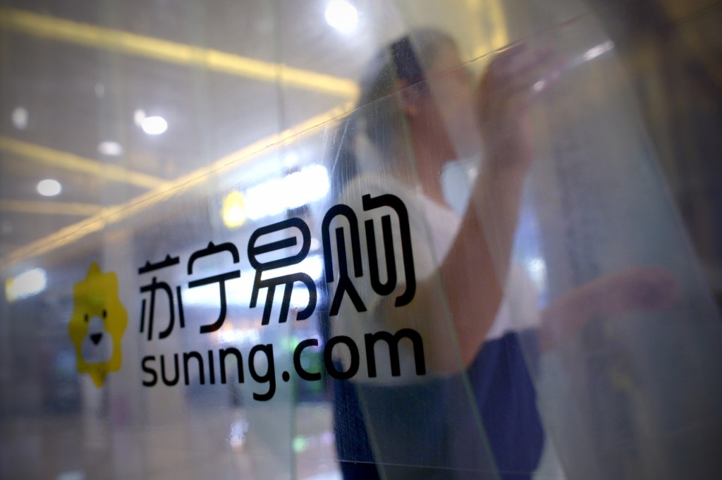 A woman walks out of a Suning store in Beijing on June 6, 2016. Chinese electronics giant Suning said it will take a majority stake in Italy's Inter Milan, making the three-time European champions the most high-profile acquisition yet by investors from China. / AFP / POOL / WANG ZHAO (Photo credit should read WANG ZHAO/AFP/Getty Images)