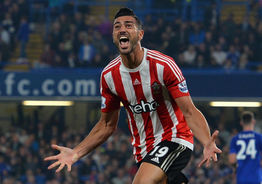 Southampton's Italian striker Graziano Pelle celebrates after scoring their third goal during the English Premier League football match between Chelsea and Southampton at Stamford Bridge in London on October 3, 2015. Southampton won the game 3-1. AFP PHOTO / GLYN KIRK RESTRICTED TO EDITORIAL USE. No use with unauthorized audio, video, data, fixture lists, club/league logos or 'live' services. Online in-match use limited to 75 images, no video emulation. No use in betting, games or single club/league/player publications. (Photo credit should read GLYN KIRK/AFP/Getty Images)