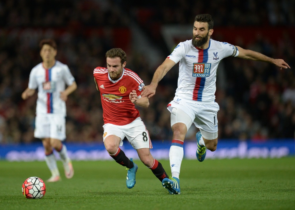 Manchester United's Spanish midfielder Juan Mata (C) is tackled by Crystal Palace's Australian midfielder Mile Jedinak during the English Premier League football match between Manchester United and Crystal Palace at Old Trafford in Manchester, north west England, on April 20, 2016. / AFP / OLI SCARFF / RESTRICTED TO EDITORIAL USE. No use with unauthorized audio, video, data, fixture lists, club/league logos or 'live' services. Online in-match use limited to 75 images, no video emulation. No use in betting, games or single club/league/player publications. / (Photo credit should read OLI SCARFF/AFP/Getty Images)