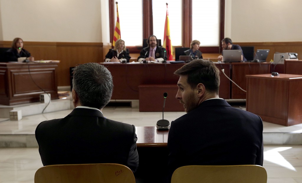 Barcelona's football star Lionel Messi (R) and his father Jorge Horacio Messi listen as they face judges in a tax fraud case at the courthouse of Barcelona on June 2, 2016. The 28-year-old football star was cheered and jeered as he emerged from a van accompanied by his father Jorge Horacio Messi. The two are accused of using a chain of fake companies in Belize and Uruguay to avoid paying taxes on 4.16 million euros ($4.6 million) of Messi's income earned through the sale of his image rights from 2007-09. AFP PHOTO/ POOL/ ALBERTO ESTEVEZ / AFP / POOL / Alberto Estevez (Photo credit should read ALBERTO ESTEVEZ/AFP/Getty Images)