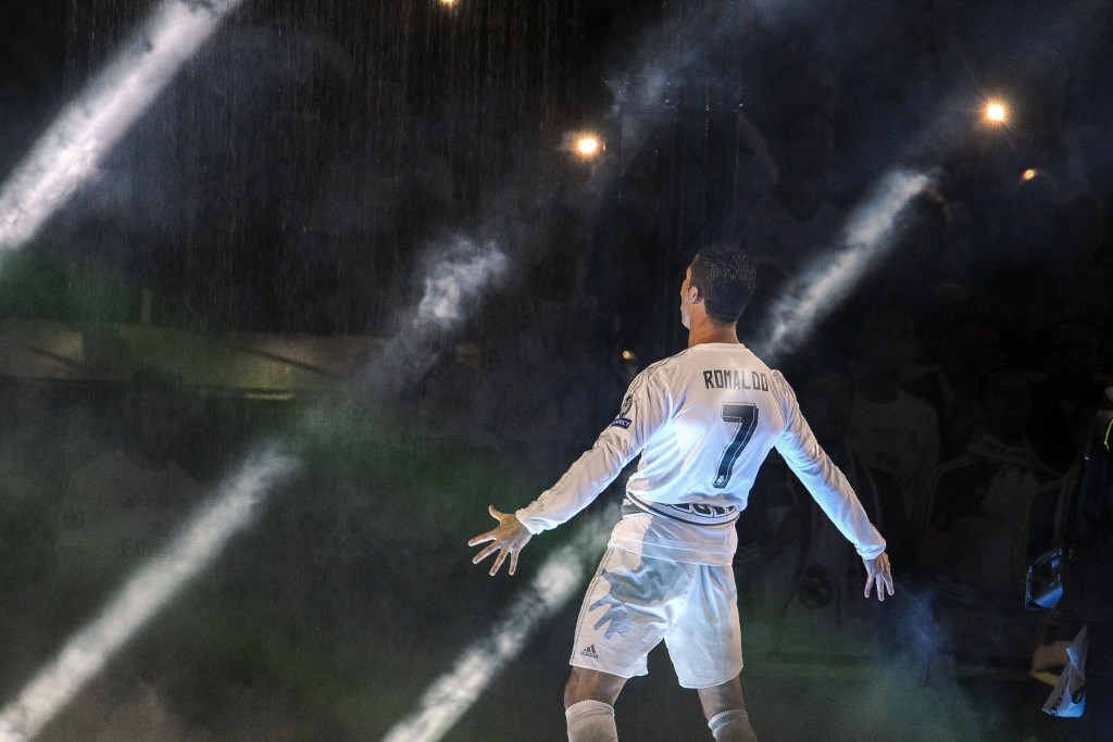Real Madrid's Portuguese forward Cristiano Ronaldo gestures to supporters during celebrations for their 11th UEFA Champions Cup at the Santiago Bernabeu stadium in Madrid on May 29, 2016, a day after winning the UEFA Champions League final foobtall match between Real Madrid CF, Club Atletico de Madrid held in Milan, Italy on May 28, 2016. / AFP / PEDRO ARMESTRE (Photo credit should read PEDRO ARMESTRE/AFP/Getty Images)
