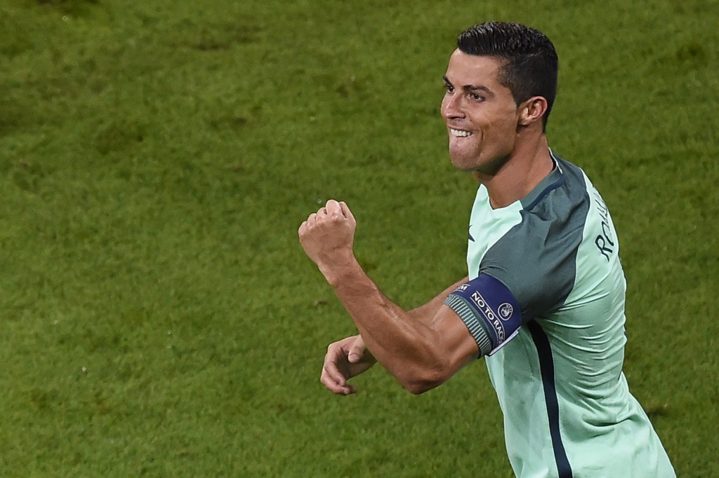 Portugal's forward Cristiano Ronaldo celebrates scoring the opening goal during the Euro 2016 semi-final football match between Portugal and Wales at the Parc Olympique Lyonnais stadium in Décines-Charpieu, near Lyon, on July 6, 2016. / AFP / ROMAIN LAFABREGUE (Photo credit should read ROMAIN LAFABREGUE/AFP/Getty Images)