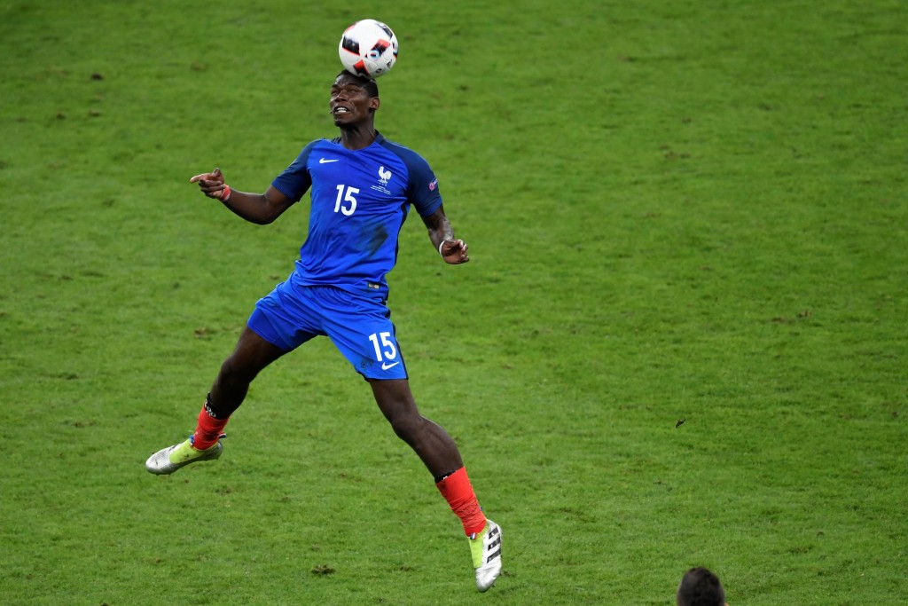France's midfielder Paul Pogba heads the ball during the Euro 2016 final football match between Portugal and France at the Stade de France in Saint-Denis, north of Paris, on July 10, 2016. (Photo credit: Miguel Medina/AFP/Getty Images)