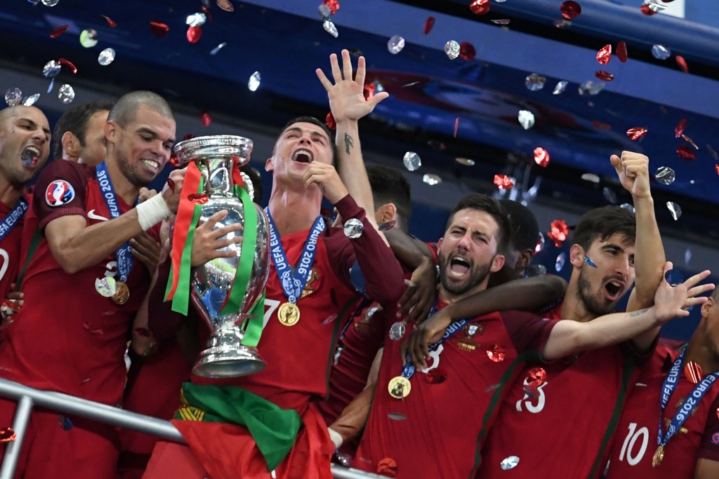 Portugal's forward Cristiano Ronaldo (3rdL) lifts the trophy as he celebrates with teammates (fromL) Portugal's forward Ricardo Quaresma, Portugal's defender Pepe, Portugal's midfielder Joao Moutinho and Portugal's midfielder Andre Gomes after they won the Euro 2016 final football match between Portugal and France at the Stade de France in Saint-Denis, north of Paris, on July 10, 2016. / AFP / FRANCISCO LEONG (Photo credit should read FRANCISCO LEONG/AFP/Getty Images)
