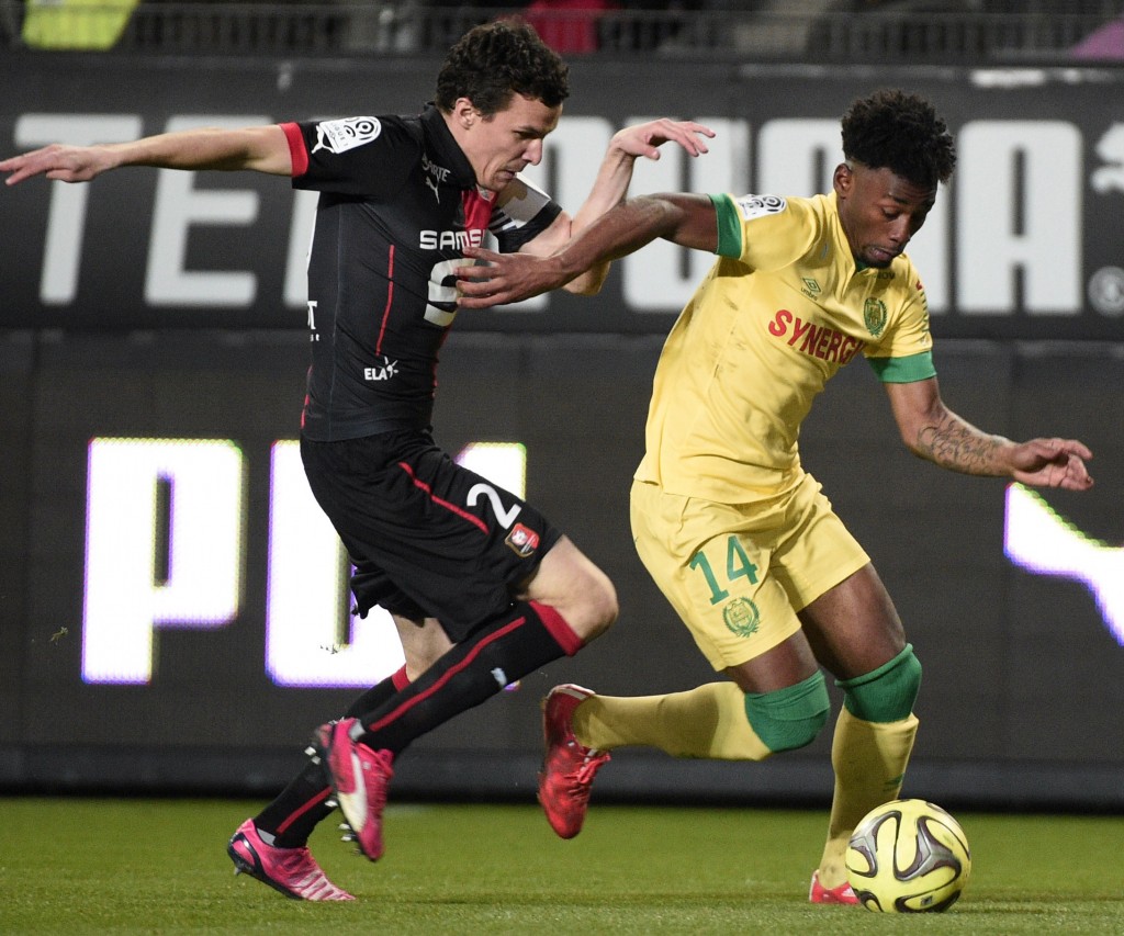 Nantes' French midfielder Georges Kevin Nkoudou (C) vies with Rennes' French defender Romain Danze (L) during the French L1 football match Rennes against Nantes on March 21, 2015 at the route de Lorient stadium in Rennes, western France. AFP PHOTO / DAMIEN MEYER (Photo credit should read DAMIEN MEYER/AFP/Getty Images)