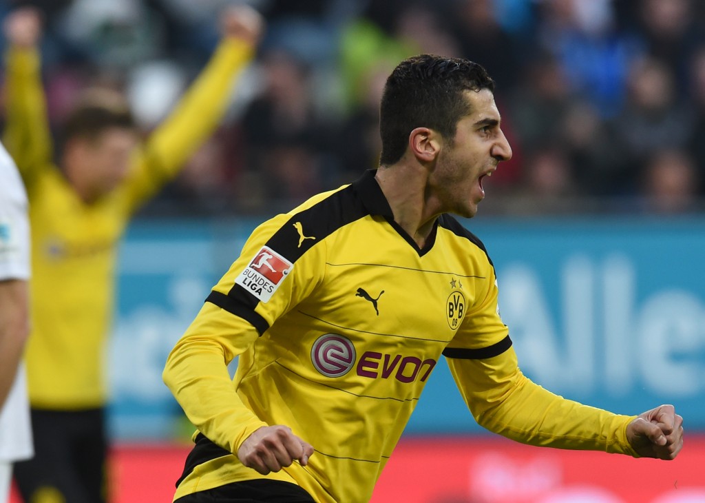 Dortmund's Armenian midfielder Henrikh Mkhitaryan celebrates after scoring during the German Bundesliga first division football match between FC Augsburg vs Borussia Dortmund in Augsburg, southern Germany, on March 20, 2016. / AFP / CHRISTOF STACHE / RESTRICTIONS: DURING MATCH TIME: DFL RULES TO LIMIT THE ONLINE USAGE TO 15 PICTURES PER MATCH AND FORBID IMAGE SEQUENCES TO SIMULATE VIDEO. == RESTRICTED TO EDITORIAL USE == FOR FURTHER QUERIES PLEASE CONTACT DFL DIRECTLY AT + 49 69 650050 (Photo credit should read CHRISTOF STACHE/AFP/Getty Images)