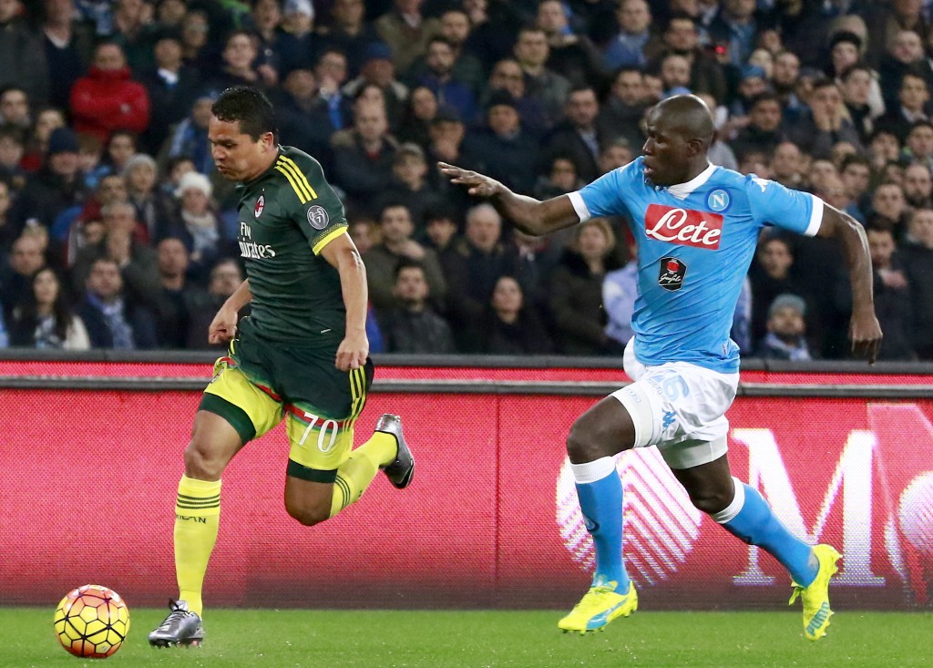 AC Milan's Colombian forward Carlos Bacca runs for the ball against Napoli's French defender Kalidou Koulibaly (R) during the Italian Serie A football match SSC Napoli vs AC Milan on February 22, 2016 at the San Paolo stadium in Naples. / AFP / CARLO HERMANN (Photo credit should read CARLO HERMANN/AFP/Getty Images)