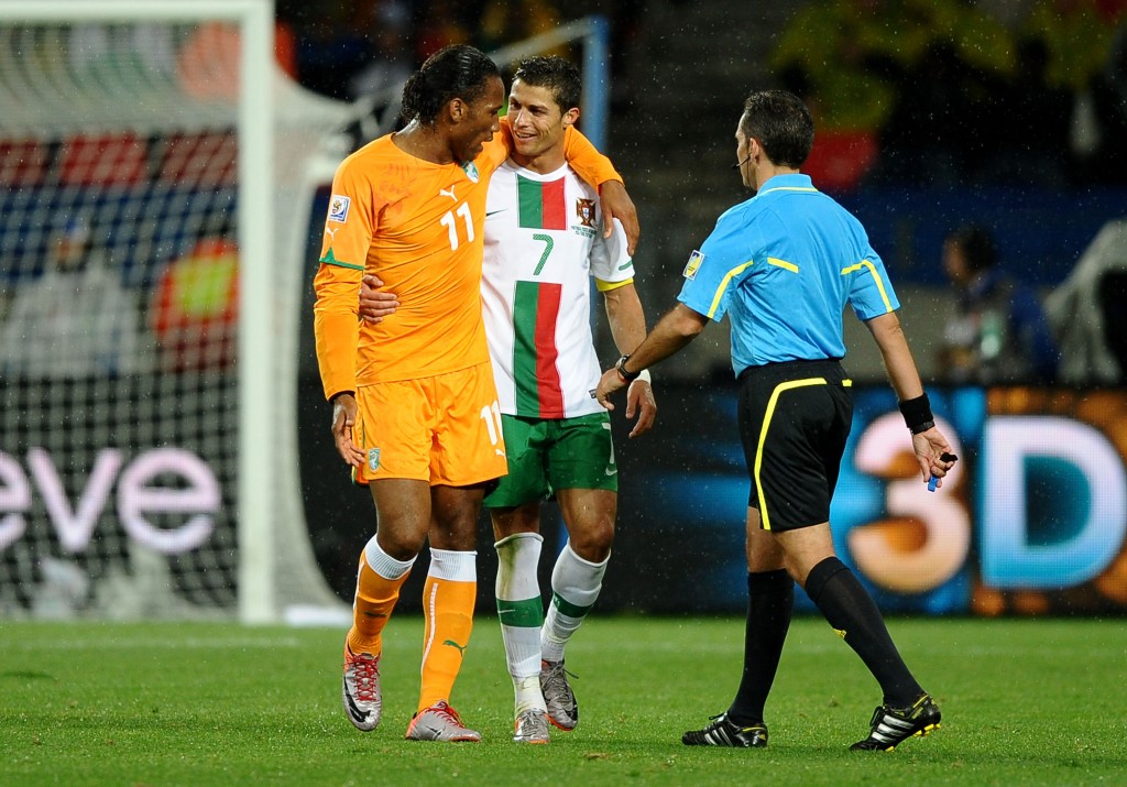PORT ELIZABETH, SOUTH AFRICA - JUNE 15: Didier Drogba of Ivory Coast puts his arm around Cristiano Ronaldo of Portugal during the 2010 FIFA World Cup South Africa Group G match between Ivory Coast and Portugal at Nelson Mandela Bay Stadium on June 15, 2010 in Port Elizabeth, South Africa. (Photo by Laurence Griffiths/Getty Images)