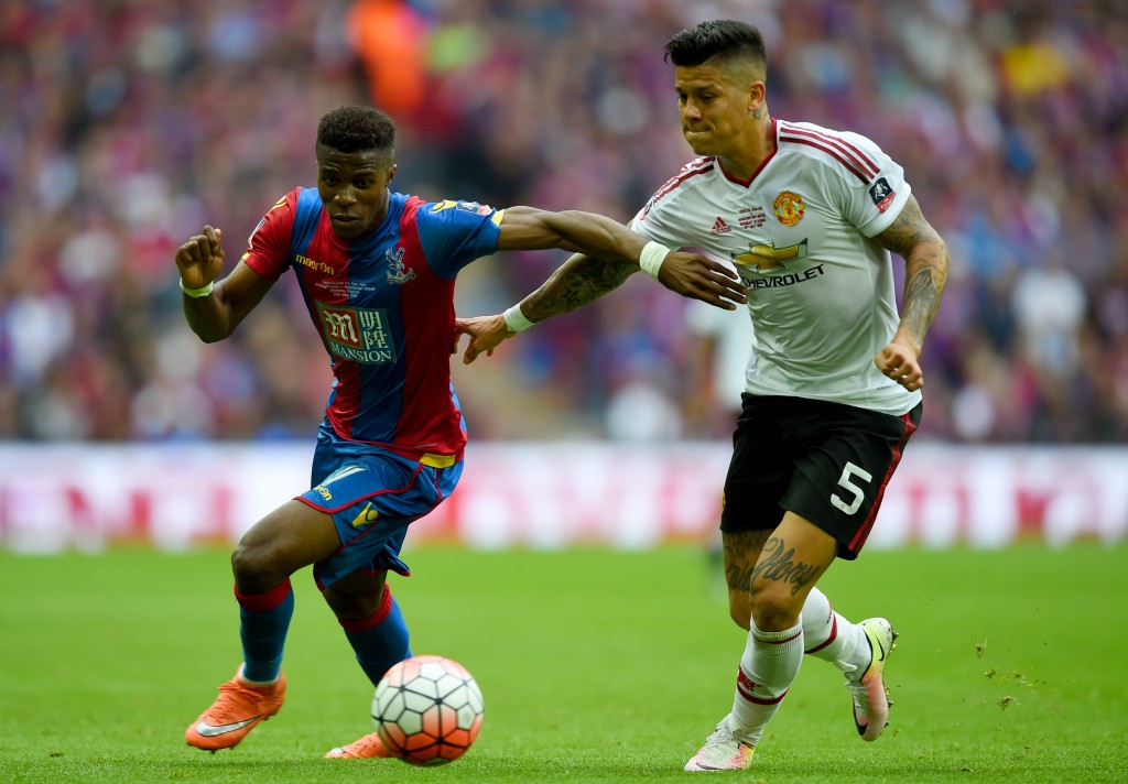 LONDON, ENGLAND - MAY 21: Wilfried Zaha of Crystal Palace battles with Marcos Rojo of Manchester United during The Emirates FA Cup Final match between Manchester United and Crystal Palace at Wembley Stadium on May 21, 2016 in London, England. (Photo by Shaun Botterill/Getty Images)