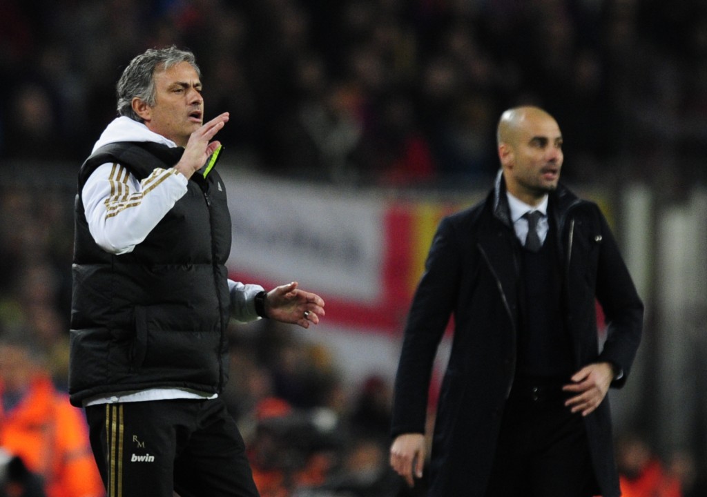 Real Madrid's Portuguese coach Jose Mourinho (L) gestures in front of Barcelona's coach Josep Guardiola (R) after Real Madrid's defender Sergio Ramos received a red card during the second leg of the Spanish Cup quarter-final "El clasico" football match Barcelona vs Real Madrid at the Camp Nou stadium in Barcelona on January 25, 2012. AFP PHOTO/JAVIER SORIANO (Photo credit should read JAVIER SORIANO/AFP/Getty Images)