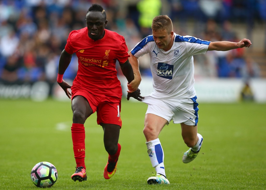 BIRKENHEAD, ENGLAND - JULY 08: Sadio Mane of Liverpool gets past Jay Harris of Tranmere Rovers during the Pre-Season Friendly match between Tranmere Rovers and Liverpool at Prenton Park on July 8, 2016 in Birkenhead, England. (Photo by Dave Thompson/Getty Images)