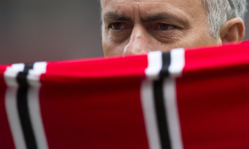 Manchester United's new Portuguese manager Jose Mourinho poses with a scarf on the pitch during a photocall at Old Trafford stadium in Manchester, northern England, on July 5, 2016. Jose Mourinho officially started work as Manchester United manager at the club's Carrington training base yesterday. The 53-year-old was appointed as United boss in May after the sacking of Dutchman Louis van Gaal. / AFP / OLI SCARFF (Photo credit should read OLI SCARFF/AFP/Getty Images)
