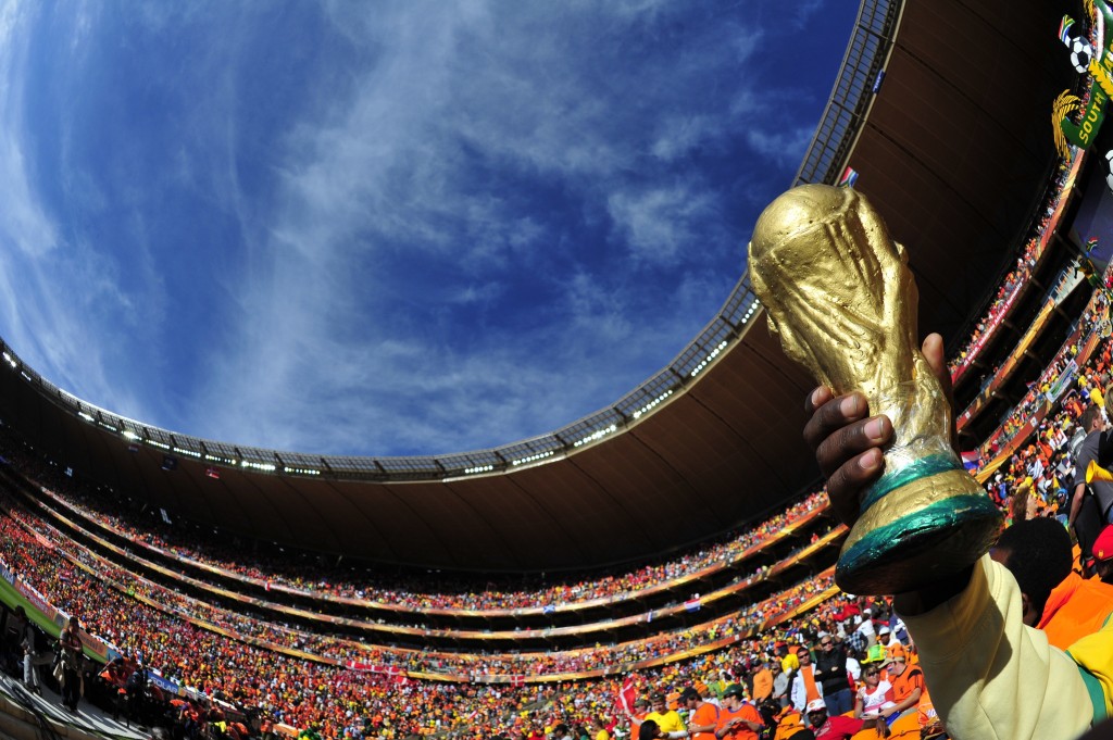 A fan holds a replica Jules Rimet World Cup trophy while watching the game on June 14, 2010, at the 2010 World Cup match Netherlands and Denmark at Soccer City Stadium in Soweto, suburban Johannesburg. Netherlands defeated Denmark 2-0. - NO PUSH TO MOBILE / MOBILE USE SOLELY WITHIN EDITORIAL ARTICLE - AFP PHOTO/Monirul Bhuiyan (Photo credit should read Monirul Bhuiyan/AFP/Getty Images)