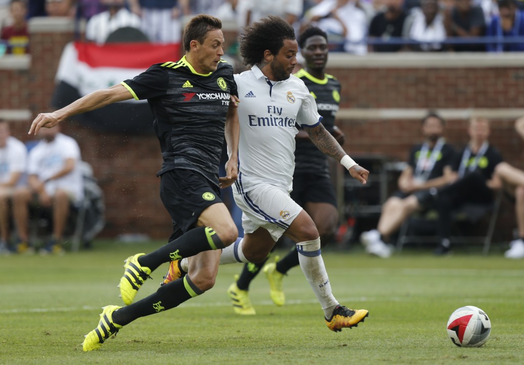 Real Madrid defender Marcelo Vieira da Silva (R) dribbles the ball past Chelsea defender Gary Cahill (L) during an International Champions Cup soccer match in Ann Arbor, Michigan on July 30, 2016. / AFP / Jay LaPrete (Photo credit should read JAY LAPRETE/AFP/Getty Images)