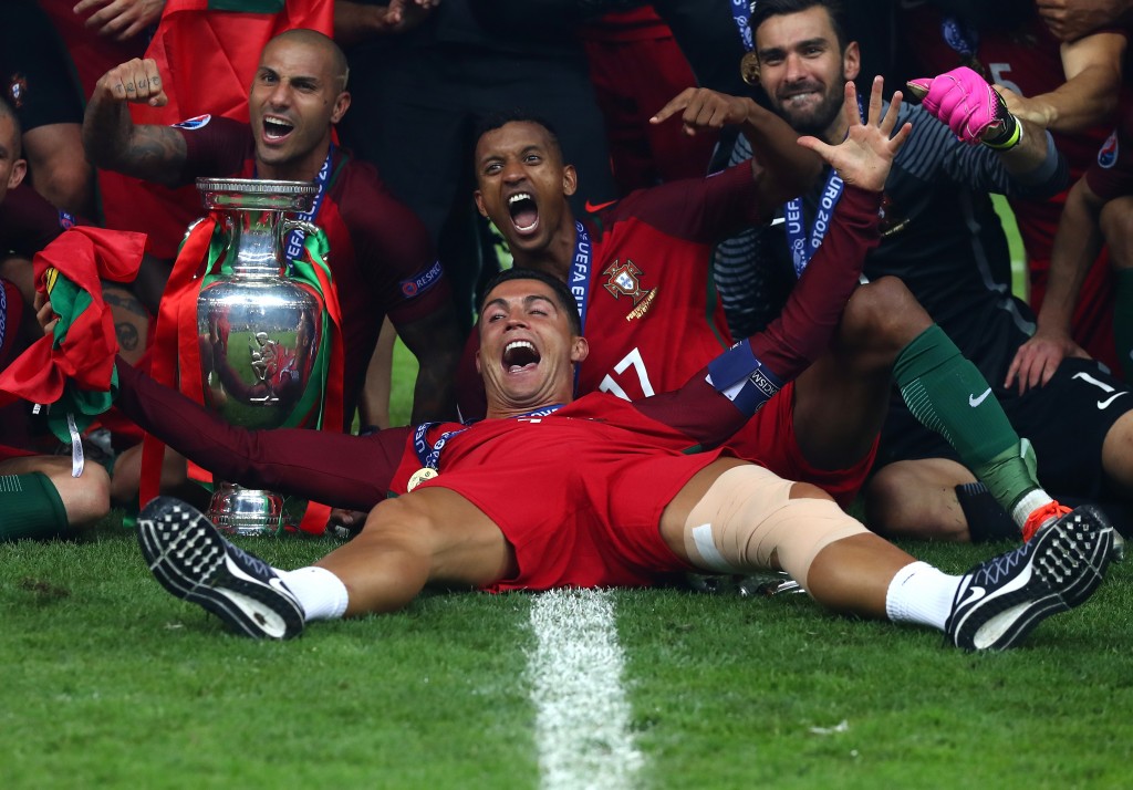 PARIS, FRANCE - JULY 10: Cristiano Ronaldo and Portugal players celebrate after their 1-0 win against France in the UEFA EURO 2016 Final match between Portugal and France at Stade de France on July 10, 2016 in Paris, France. (Photo by Lars Baron/Getty Images)