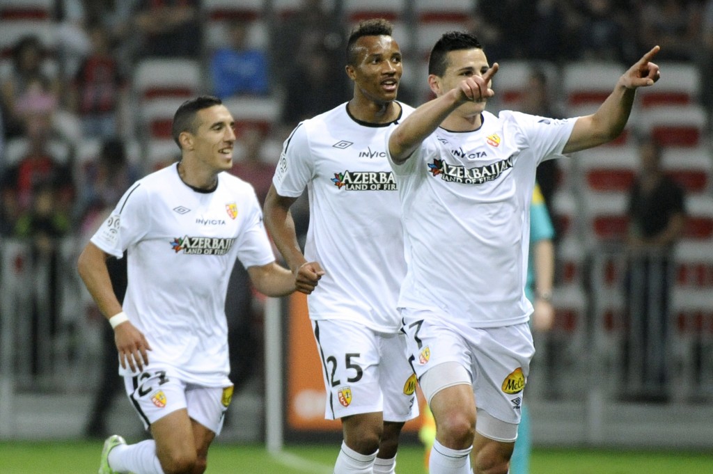 Lens' French forward Yoann Touzghar (R) celebrates after scoring a goal during the French L1 football match between OGC Nice and RC Lens at the Allianz Riviera Stadium in Nice, southeastern France, on May 16, 2015. AFP PHOTO / FRANCK PENNANT (Photo credit should read FRANCK PENNANT/AFP/Getty Images)