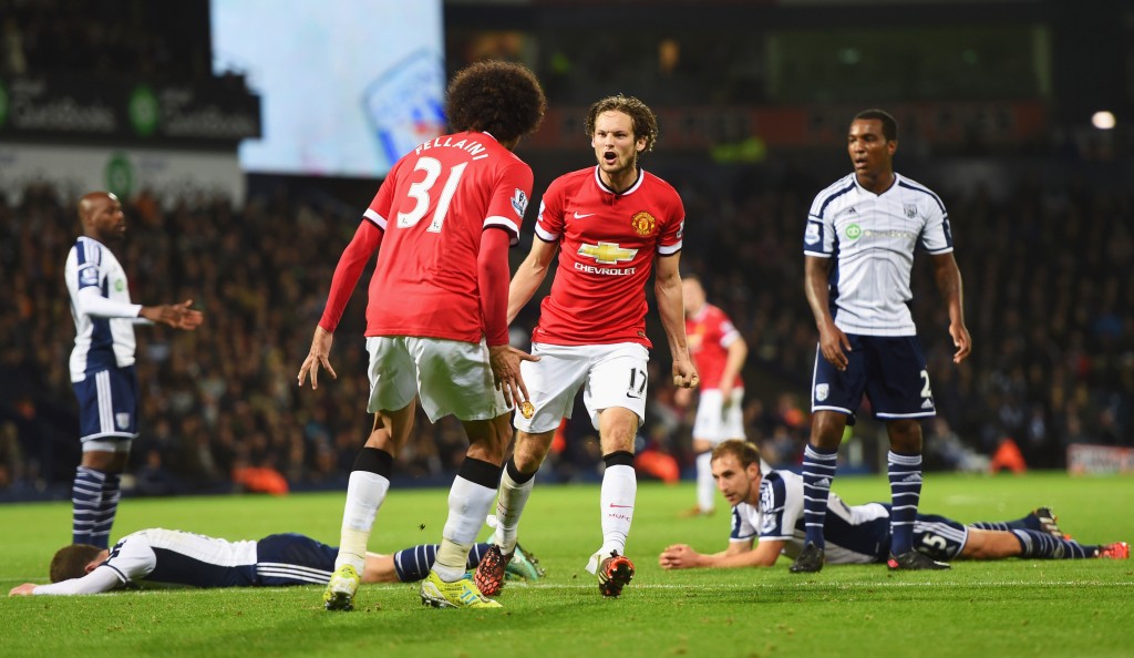 WEST BROMWICH, ENGLAND - OCTOBER 20: West Bromwich Albion defenders look dejected as Daley Blind of Manchester United (17) celebrates scoring their second and equalising goal with Marouane Fellaini during the Barclays Premier League match between West Bromwich Albion and Manchester United at The Hawthorns on October 20, 2014 in West Bromwich, England. (Photo by Michael Regan/Getty Images)