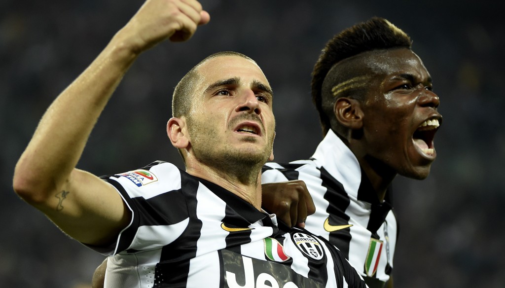 Juventus' defender Leonardo Bonucci (L) celebrates with teammate Juventus' midfielder from France Paul Pogba after scoring during the Italian Serie A football match Juventus vs Roma on October 5, 2014 at the Juventus Stadium stadium in Turin. AFP PHOTO / OLIVIER MORIN (Photo credit should read OLIVIER MORIN/AFP/Getty Images)