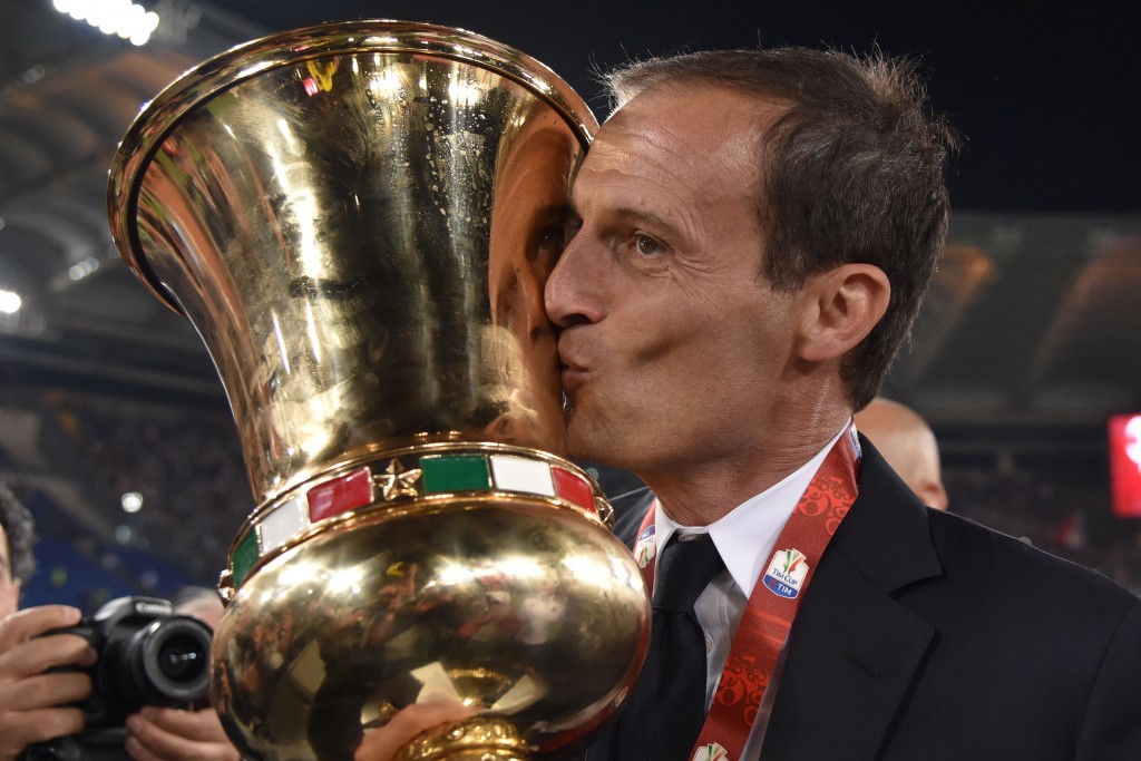 Juventus' coach from Italy Massimiliano Allegri kisses the trophy after winning the Italian Tim Cup final football match AC Milan vs Juventus on May 21, 2016 at the Olympic Stadium in Rome. Juventus won 0-1 in the extra time. AFP PHOTO / TIZIANA FABI / AFP / TIZIANA FABI (Photo credit should read TIZIANA FABI/AFP/Getty Images)