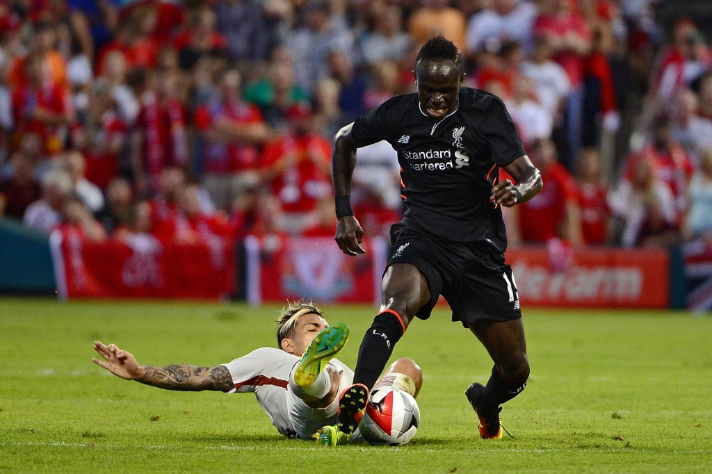 ST LOUIS, MO - AUGUST 01: Sadio Man #19 of Liverpool FC handles the ball as Leandro Paredes #5 of AS Roma slides to defend during a friendly match at Busch Stadium on August 1, 2016 in St Louis, Missouri. AC Roma won 2-1. (Photo by Jeff Curry/Getty Images)