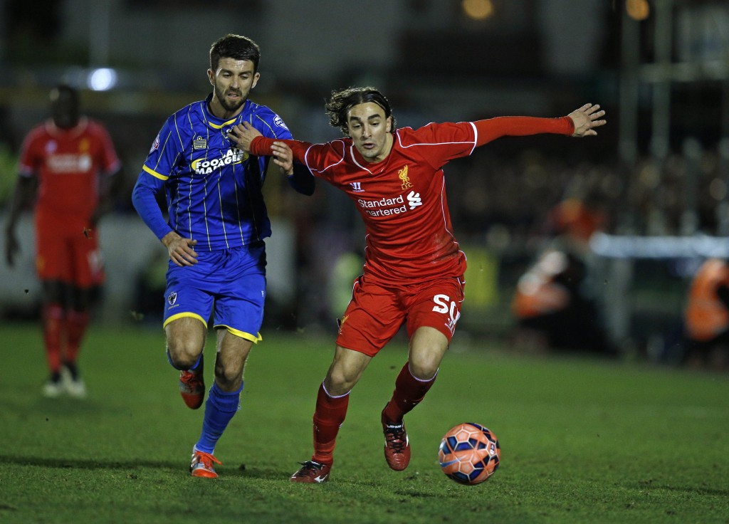 Liverpool's Serbian midfielder Lazar Markovic (R) vies with AFC Wimbledon's English defender George Francomb (L) during the English FA Cup third round football match between AFC Wimbledon and Liverpool at The Cherry Red Records Stadium in Kingston Upon Thames, south west London on January 5, 2015. AFP PHOTO / ADRIAN DENNIS RESTRICTED TO EDITORIAL USE. No use with unauthorized audio, video, data, fixture lists, club/league logos or live services. Online in-match use limited to 45 images, no video emulation. No use in betting, games or single club/league/player publications. (Photo credit should read ADRIAN DENNIS/AFP/Getty Images)