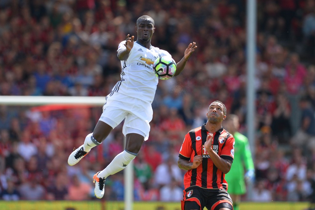 Manchester United's Ivorian defender Eric Bailly (L) leaps to control the ball next to Bournemouth's English striker Callum Wilson (R) during the English Premier League football match between Bournemouth and Manchester United at the Vitality Stadium in Bournemouth, southern England on August 14, 2016. (Photo credit: Glyn Kirk/AFP/Getty Images)