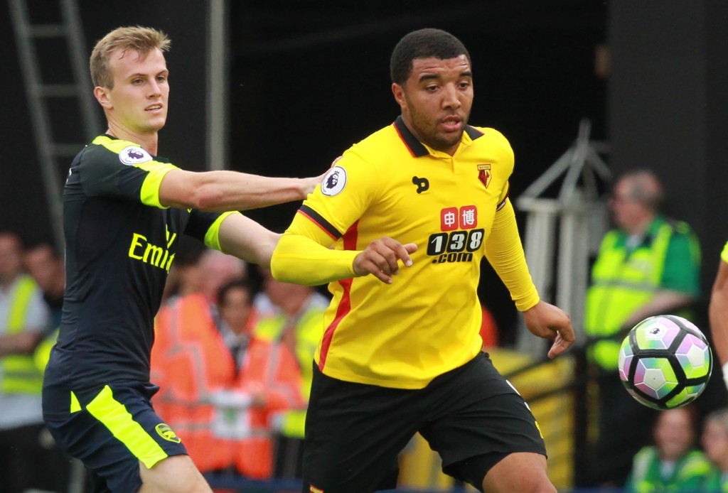 Watford's English striker Troy Deeney (R) vies with Arsenal's English defender Rob Holding during the English Premier League football match between Watford and Arsenal at Vicarage Road Stadium in Watford, north of London on August 27, 2016. / AFP / Sean Dempsey / RESTRICTED TO EDITORIAL USE. No use with unauthorized audio, video, data, fixture lists, club/league logos or 'live' services. Online in-match use limited to 75 images, no video emulation. No use in betting, games or single club/league/player publications. / (Photo credit should read SEAN DEMPSEY/AFP/Getty Images)