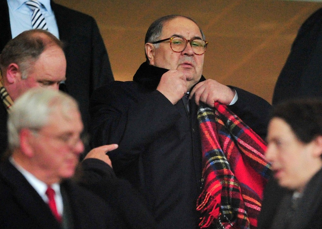 Arsenal shareholder Alisher Usmanov (C) attends the UEFA Champions League Last 16, first leg football match between Arsenal and Bayern Munich at The Emirates Stadium in north London on February 19, 2014. AFP PHOTO / GLYN KIRK (Photo credit should read GLYN KIRK/AFP/Getty Images)