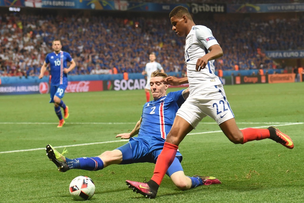 Iceland's defender Birkir Saevarsson (L) vies for the ball against England's forward Marcus Rashford during Euro 2016 round of 16 football match between England and Iceland at the Allianz Riviera stadium in Nice on June 27, 2016. / AFP / PAUL ELLIS (Photo credit should read PAUL ELLIS/AFP/Getty Images)