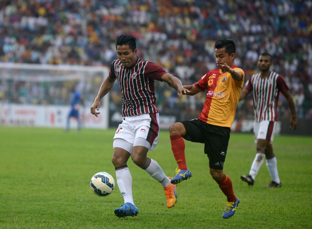 Mohun Bagan Dhanachandra Singh(L) is tackled by East Bengal's Sanju Pradhan(R) during an I-League football match at The Kanchenjungha Stadium in Siliguri on April 2, 2016. East Bengal won the match 2-1. / AFP / DIPTENDU DUTTA (Photo credit should read DIPTENDU DUTTA/AFP/Getty Images)