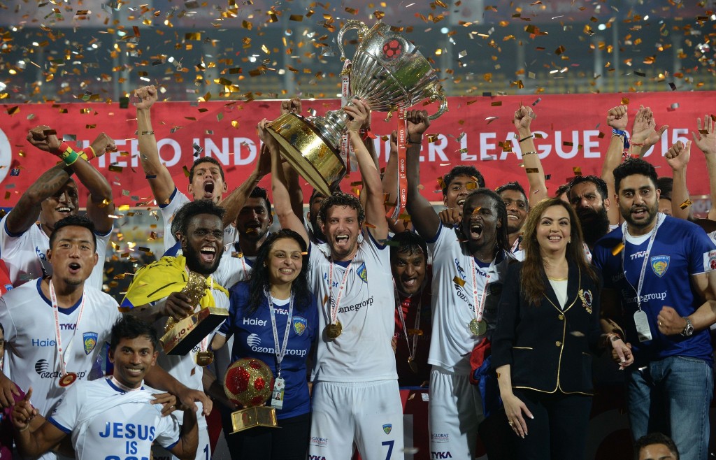 Chennaiyin FC players pose with the trophy as they celebrate along with Bollywood actor Abhishek Bachchan (R) and Nita Ambani (3R) after winning the final match against FC Goa during the Indian Super League (ISL) football tournament at Jawahar Lal Nehru Stadium in Goa on December 20, 2015. AFP PHOTO / PUNIT PARANJPE / AFP / PUNIT PARANJPE (Photo credit should read PUNIT PARANJPE/AFP/Getty Images)