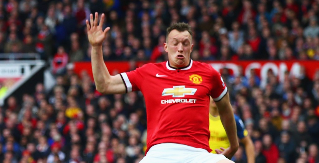 MANCHESTER, ENGLAND - MAY 17: Santi Cazorla of Arsenal is blocked by Phil Jones of Manchester United during the Barclays Premier League match between Manchester United and Arsenal at Old Trafford on May 17, 2015 in Manchester, England. (Photo by Clive Rose/Getty Images)