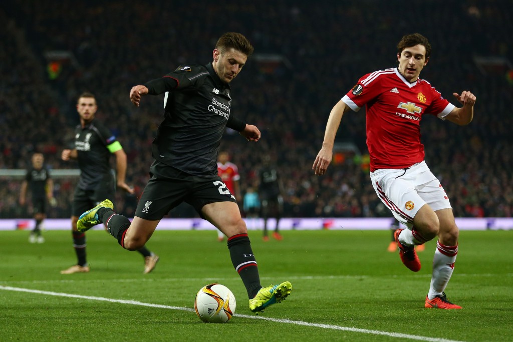 MANCHESTER, ENGLAND - MARCH 17: Adam Lallana of Liverpool is faced by Matteo Darmian of Manchester United during the UEFA Europa League round of 16, second leg match between Manchester United and Liverpool at Old Trafford on March 17, 2016 in Manchester, England. (Photo by Clive Brunskill/Getty Images)