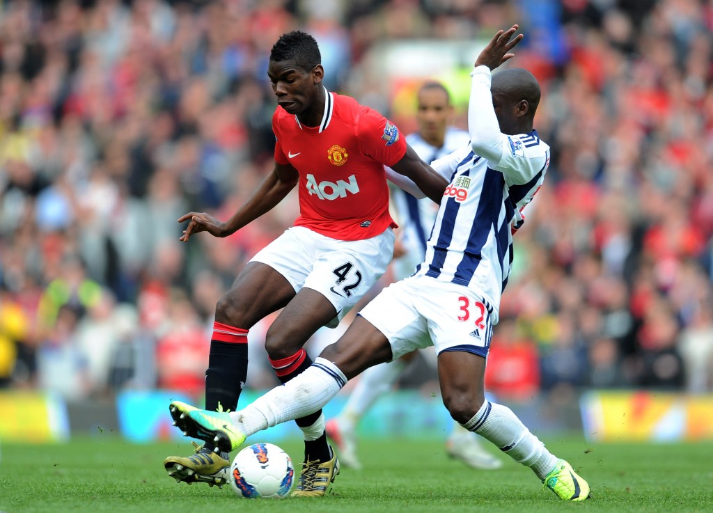 MANCHESTER, ENGLAND - MARCH 11: Paul Pogba of Manchester United is challenged by Marc-Antoine Fortune of West Bromwich Albionduring the Barclays Premier League match between Manchester United and West Bromwich Albion at Old Trafford on March 11, 2012 in Manchester, England. (Photo by Michael Regan/Getty Images)