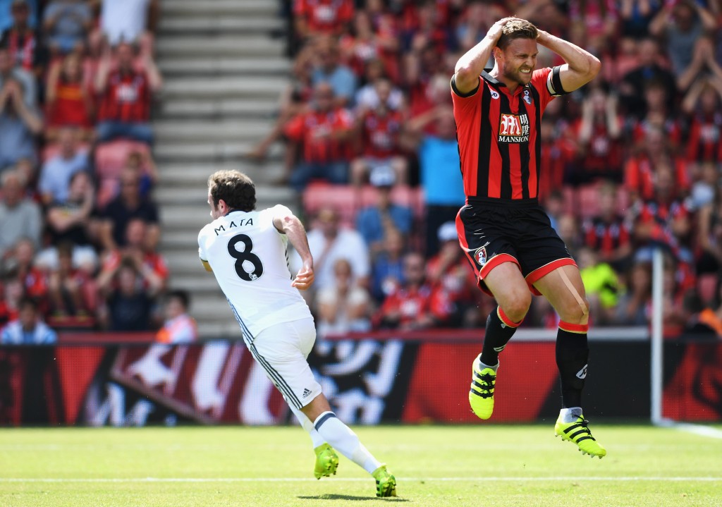 BOURNEMOUTH, ENGLAND - AUGUST 14: Juan Mata of Manchester United turns away after scoring the opening goal as Simon Francis of AFC Bournemouth reacts during the Premier League match between AFC Bournemouth and Manchester United at Vitality Stadium on August 14, 2016 in Bournemouth, England.  (Photo by Stu Forster/Getty Images)