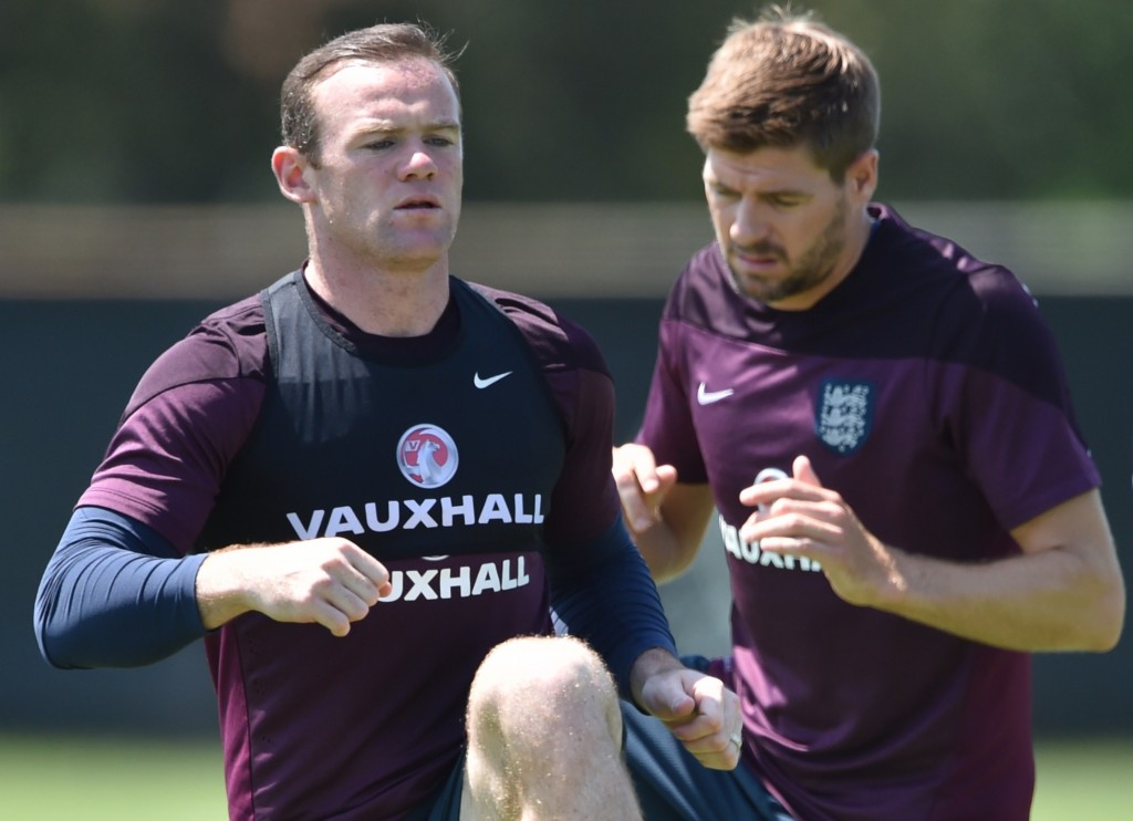 England forward Wayne Rooney and England midfielder Steven Gerrard (C) warm up during a training session at Barry University in Miami Shores, Florida on June 6, 2014. AFP PHOTO MLADEN ANTONOV (Photo credit should read MLADEN ANTONOV/AFP/Getty Images)