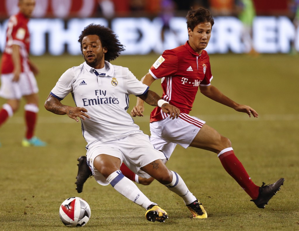 EAST RUTHERFORD, NJ - AUGUST 03: Marcelo Vieira Da Silva #12 of Real Madrid drives by Fabian Benko #40 of Bayern Munich during their International Champions Cup match at MetLife Stadium on August 3, 2016 in East Rutherford, New Jersey. (Photo by Jeff Zelevansky/Getty Images)