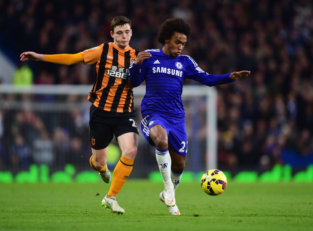 LONDON, ENGLAND - DECEMBER 13: Willian of Chelsea holds off Andrew Robertson of Hull City during the Barclays Premier League match between Chelsea and Hull City at Stamford Bridge on December 13, 2014 in London, England. (Photo by Jamie McDonald/Getty Images)