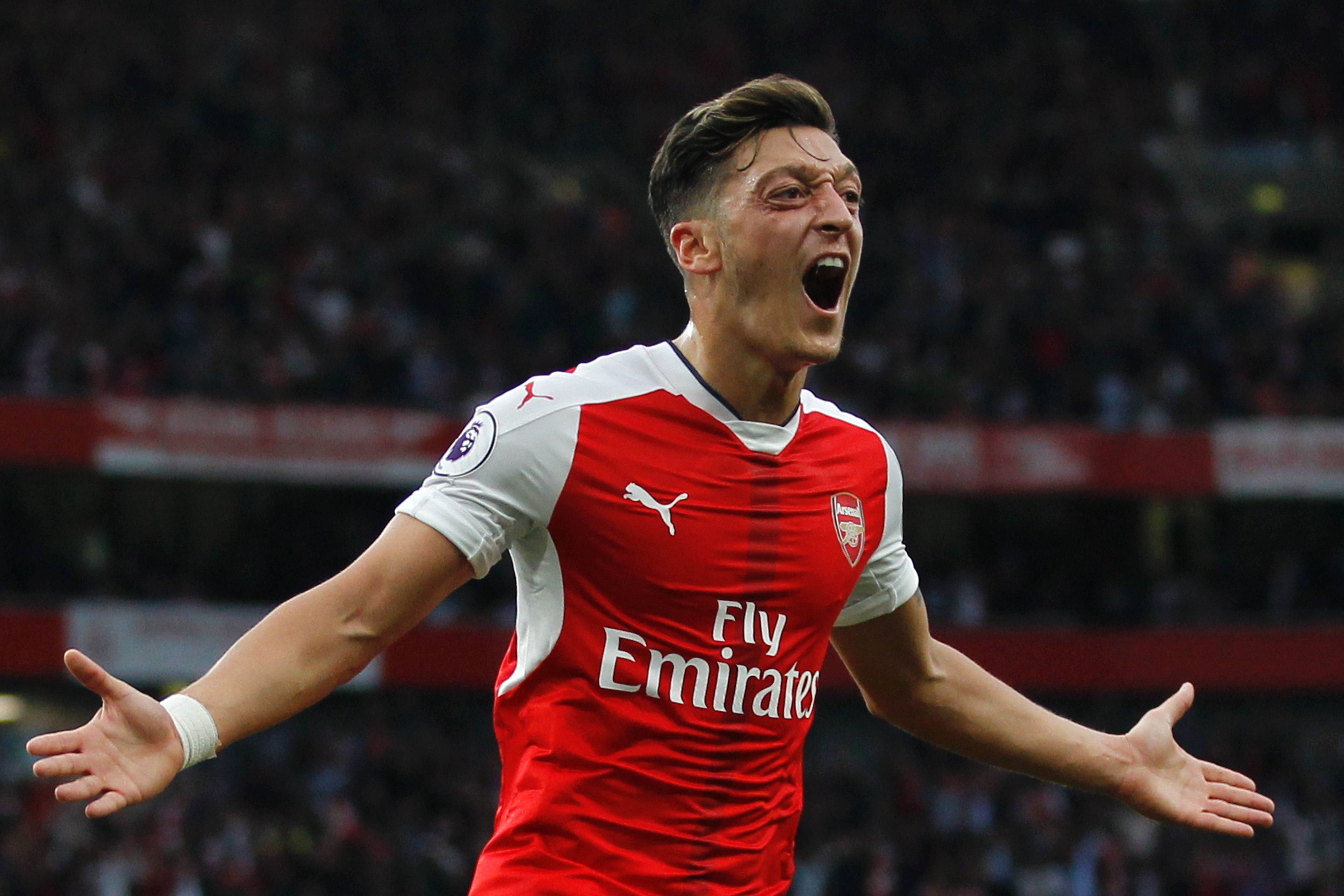 Arsenal's German midfielder Mesut Ozil celebrates scoring their third goal during the English Premier League football match between Arsenal and Chelsea at The Emirates stadium in London, on September 24, 2016. (Photo credit: Ian Kington/AFP/Getty Images)
